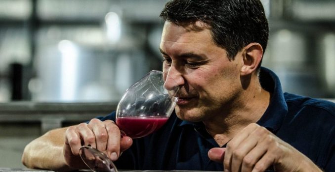 Winemaker Scott Heidrich tasting wine